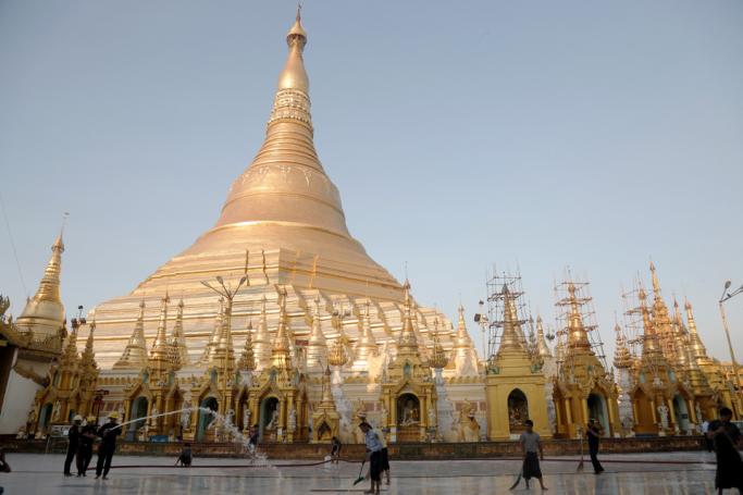 Staff cleans the Shwedagon pagoda compound amid concerns of the spread of the COVID-19 novel coronavirus in Yangon on March 26, 2020. Photo: Sai Aung Main/AFP