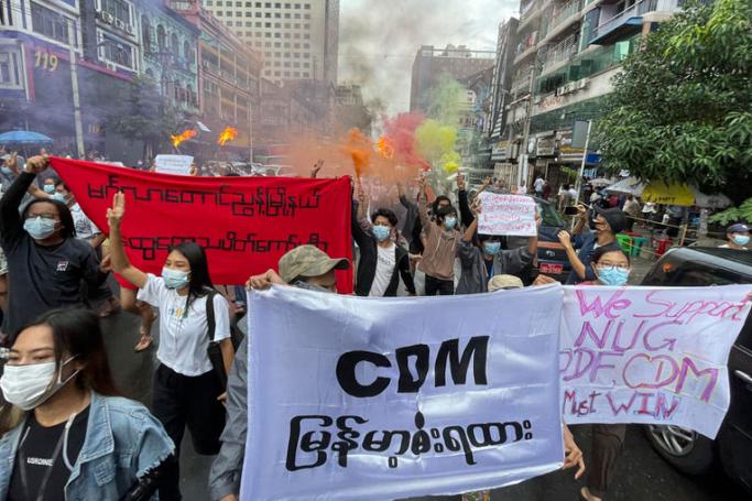  Demonstrators holding posters and banners march during an anti-military coup protest at downtown area in Yangon, Myanmar, 26 June 2021. Photo: EPA
