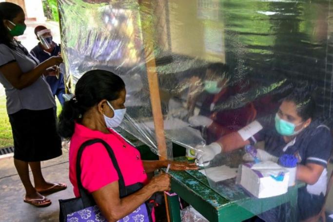 Sri Lanka trialled new health measures in four of the 22 electoral districts (AFP Photo/LAKRUWAN WANNIARACHCHI)