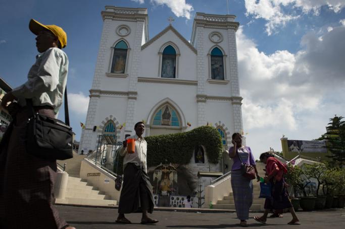 Catholics from Myanmar walk in front of St. Anthony Church in Yangon. Photo: AFP