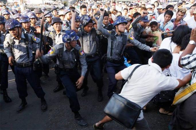 Police and civilians with red arm bands attack non-violent protesters outside Yangon City Hall on March 5, 2015. Photo: Hein Htet/Mizzima

