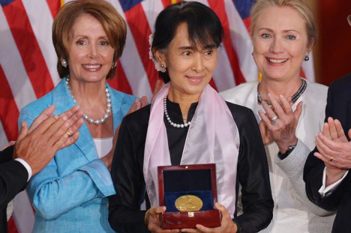 (File) Myanmar's Member of Parliament and democracy icon Aung San Suu Kyi holds the Congressional Gold Medal as she poses with House Minority Leader Nancy Pelosi, D-CA, and US Secretary of State Hillary Clinton September 19, 2012 in the Rotunda of the Capitol in Washington, DC. Photo: Mandel Ngan/AFP
