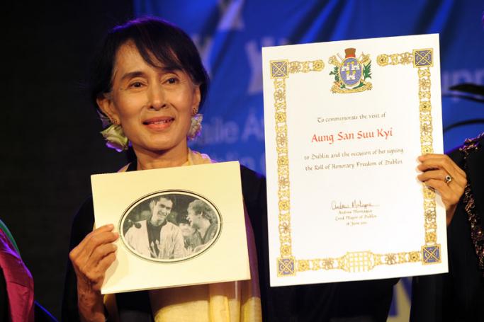 (File) Myanmar democracy icon Aung San Suu Kyi holds up the roll of honour as she receives the freedom of Dublin City at a ceremony outside the Bord Gais Energy theatre in Dublin, Ireland on 18 June 2012. Photo: Kim Haughton/EPA
