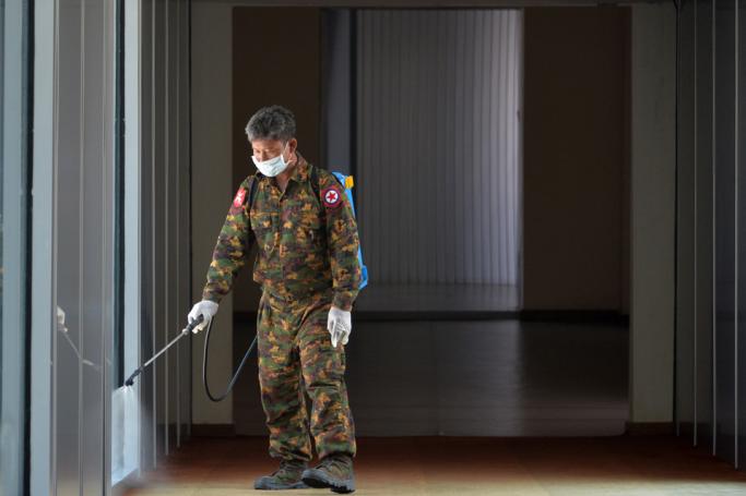 A member of Myanmar's military sprays disinfectant as a preventive measure to contain the spread of COVID-19 coronavirus at Naypyidaw International Airport in Naypyidaw on March 31, 2020. Photo: Thet Aung / AFP 