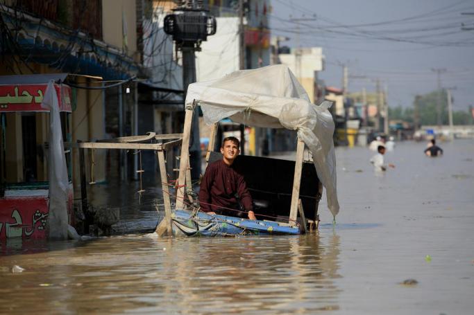 A boy sits on a street stall in a flooded area following heavy rains in Nowshera District, Khyber Pakhtunkhwa province, Pakistan, 29 August 2022. Photo: EPA