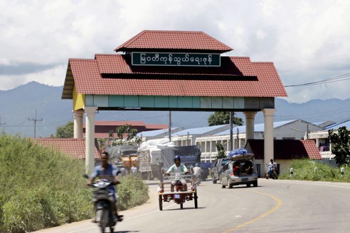 Vehicles pass around the gate of Myawaddy border trade zone, Myawaddy of Karen State, eastern Myanmar. Photo: EPA