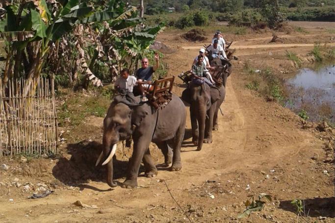 Tourists ride elephants at Thitgatoeeaing Elephant Camp. Photo: MNA
