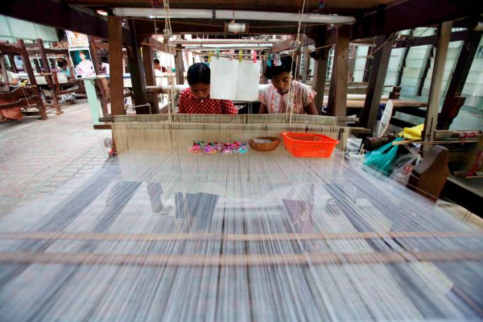 Burmese women work at a traditional textile factory in Mandalay, Myanmar. Photo: EPA