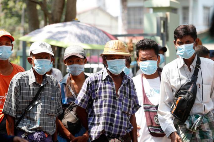 Trishaw drivers wear masks as they wait to receive free food during a food donation to low income people event amid the Covid-19 and coronavirus pandemic in Yangon, Myanmar, 07 April 2020. Photo: Nyein Chan Naing/EPA