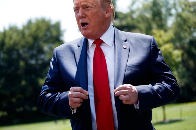 US President Donald J. Trump responds to a question from the news media as he walks to the Oval Office after stepping off Marine One on the South Lawn of the White House in Washington, DC, USA, 30 July 2019. Photo: Shawn Thew/EPA