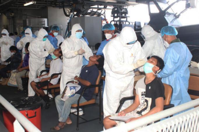 Myanmar returnees are seen undergoing medical treatment onboard the Navy vessels. Photo: MNA