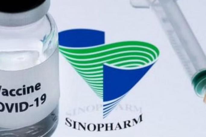This picture shows a bottle reading 'Vaccine Covid-19' next to Chinese National Pharmaceutical Sinopharm logo. Photo: AFP