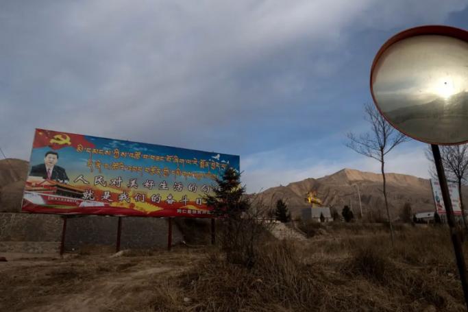 Poster showing China’s President Xi Jinping is seen next to a freeway outside of Tongren, Qinghai province. (AFP via Getty Images)