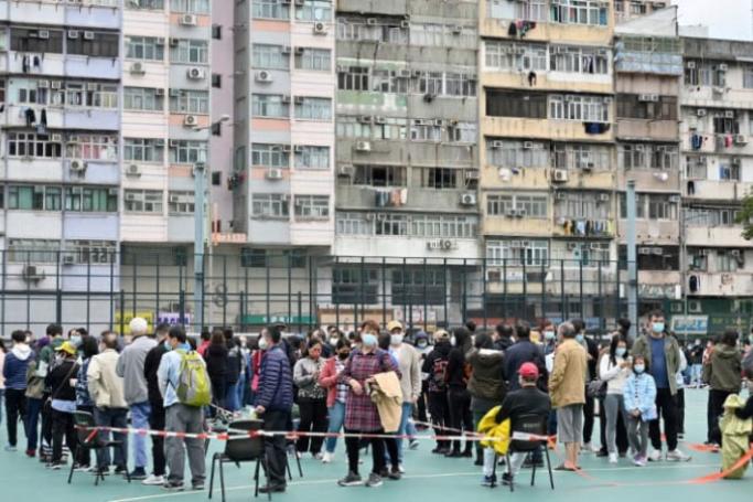 People queue at a mobile specimen collection station for Covid-19 testing in Hong Kong's Prince Edward district on February 8, 2022, as authorities scrambled to ramp up testing capacity following a record high of new infections. Photo: AFP