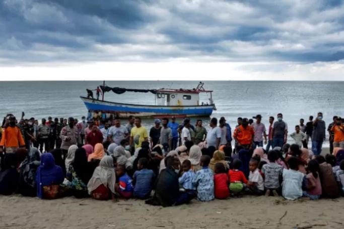 Evacuated Rohingya people from Myanmar sit on the shorelines of Lancok village, in Indonesia's North Aceh Regency. Photo: AFP