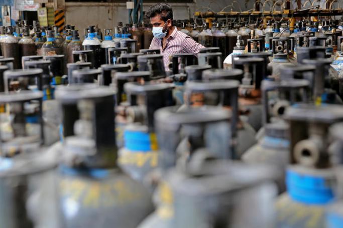 A general view showing empty oxygen cylinders returned from hospitals at oxygen filling center in Bangalore , India, 21 April 2021. Photo: EPA