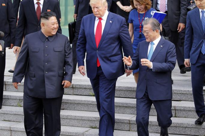 North Korean leader Kim Jong-un (L) walks with US President Donald J. Trump (C) and South Korean President Moon Jae-in (R) toward the northern side of the truce village of Panmunjom in the Demilitarized Zone, which separates the two Koreas, 30 June 2019. Photo: Yonhap/EPA