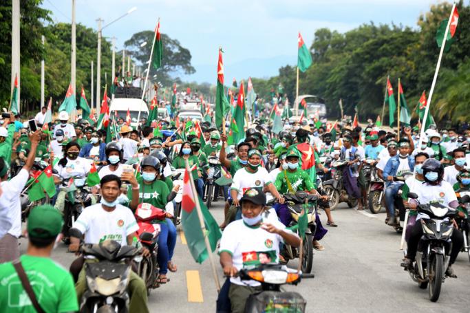 Supporters of the Union Solidarity and Development Party (USDP) wave the party's flags as they campaign in Naypyidaw on October 1, 2020, ahead of the November 8 general election. Photo: Thet Aung/AFP