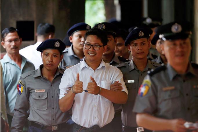 Reuters journalist Wa Lone (C) gives a thumbs-up as he arrives at Insein township court in Yangon, Myanmar, 03 September 2018. Photo: Lynn Bo Bo/EPA