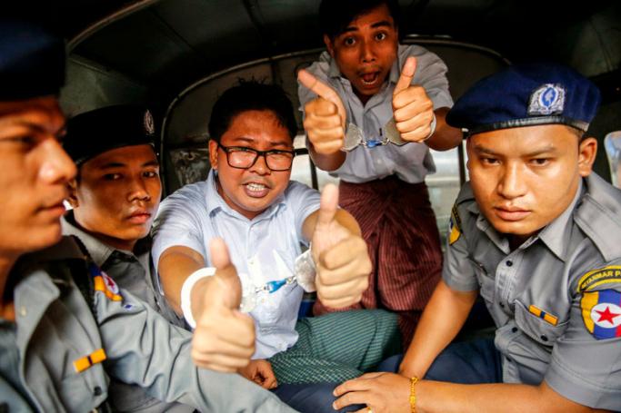 (FILE) - Reuters journalists Wa Lone (C, left) and Kyaw Soe Oo (C, right) gesture as they prepare to leave the Insein township court in Yangon, Myanmar, 03 September 2018. Photo: Lynn Bo Bo/EPA