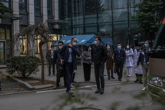 Peter Ben Embarek (C-L) leaves after visiting with other members of World Health Organization (WHO) Hubei Provincial Hospital of Integrated Chinese and Western Medicine, in Wuhan, China, 29 January 2021. Photo: EPA