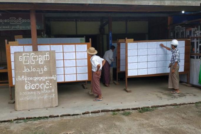 Residents in Kyundaw, Sagiang Region, check his name in the voters’ list displayed at a local administrative office on October 3, 2020. Photo: MNA