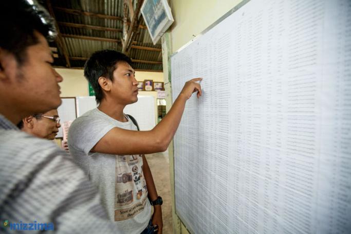 People check their name on the voters' list in Tharkayta township, Yangon on 14 September 2015. Photo: Hong Sar/Mizzima
