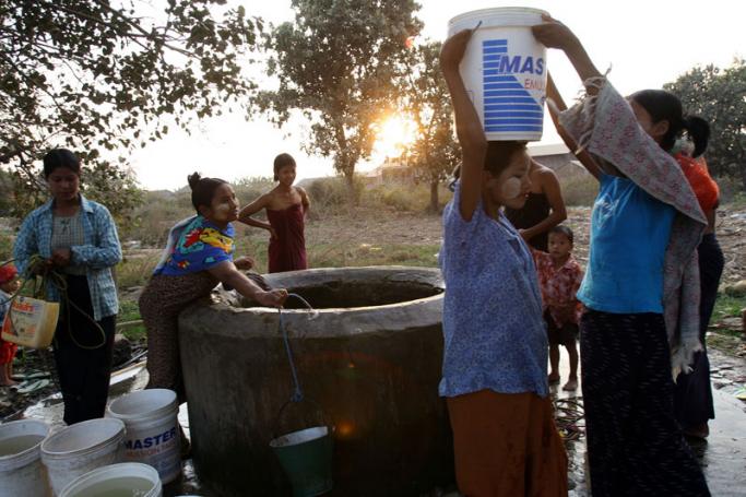 Residents carry away water for their daily usage from a well in a remote Pyinmana town close to the Myanmar's new administrative capital Nay Pyi Taw. Photo: AFP
