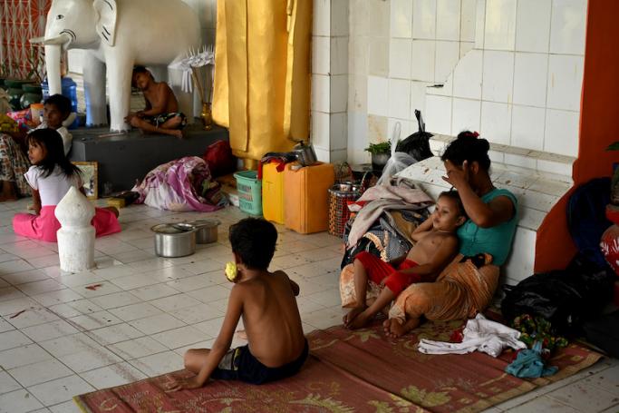 People shelter at a monastery in Sittwe town in Myanmar’s Rakhine state on May 12, 2023, ahead of the expected landfall of Cyclone Mocha. Photo: AFP