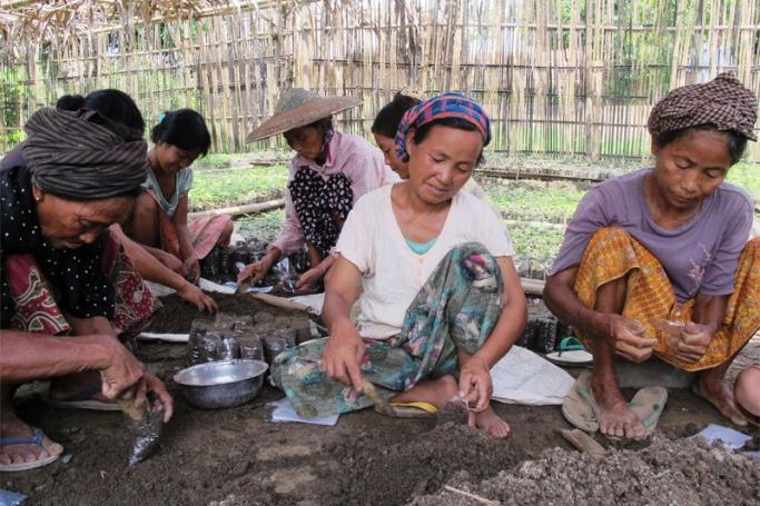 Women are under threat in conflict zones in Myanmar, according to Women's League of Burma. Women preparing plastic bags for transplanting teak and iron timber tree seedlings in In Gan village, Kachin State. Photo: OXFAM Hong Kong

