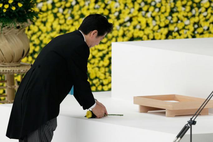 Japanese Prime Minister Shinzo Abe lays a flower during a memorial service at Nippon Budokan Hall in Tokyo, Japan, 15 August 2015. The annual ceremony marked the 70th anniversary of the end of World War II, remembering the Japanese soldiers and civilians who lost their lives. EPA/KIYOSHI OTA
