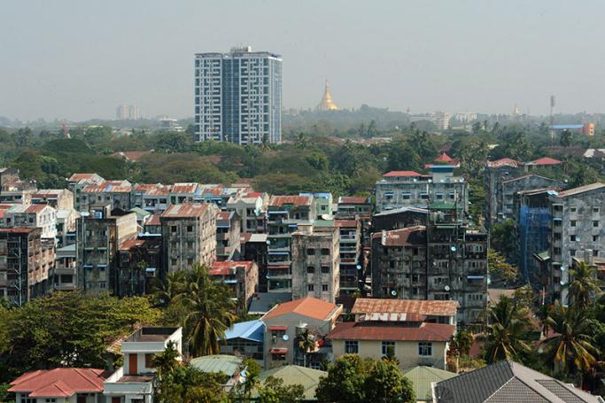 Old and new apartment blocks and commercial highrise buildings across the Yangon skyline, with Shwedagon pagoda seen in top (C).  Photo: Romeo Gacad/AFP
