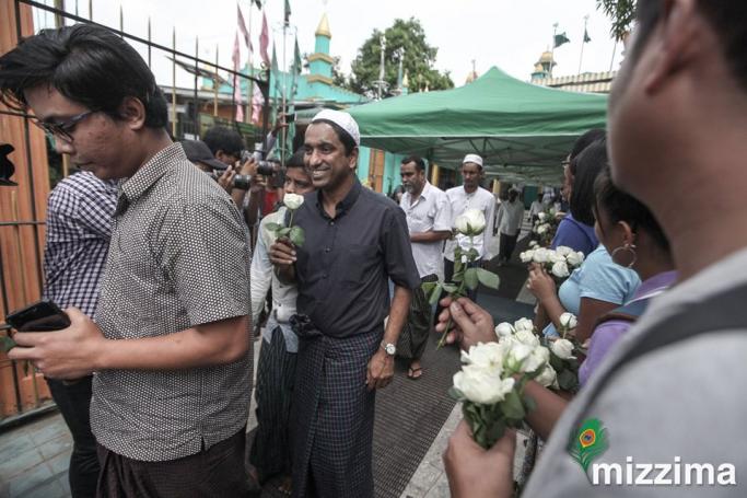 Muslims receive white roses in Yangon. Photo: Thura for Mizzima
