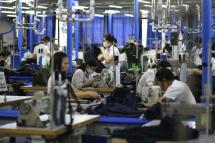 This photograph taken on May 24, 2019 shows garment factory workers making men's suits in a factory in Hanoi. Photo: AFP