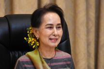 This handout from Myanmar's Ministry of Information taken and released on April 13, 2020 shows Myanmar's State Counsellor Aung San Suu Kyi talking to government officials from the Yangon region. Photo: AFP