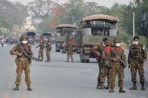 Myanmar soldiers stand guard on a road amid demonstrations against the military coup in Naypyidaw. Photo: AFP