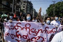 Protesters hold banners as they take part in a demonstration against the military coup in Yangon. Photo: AFP 