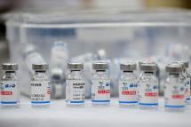 Empty vials of the Sinopharm Covid-19 coronavirus vaccine are kept on a table at a vaccination centre in Hanoi on September 10, 2021. Nhac NGUYEN / AFP
