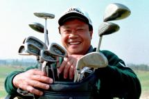 Asian PGA player Kyi Hla Han of Myanmar poses with his clubs prior to playing in the Pro-Am 08 December 1999 at the Mission Hills Golf Club in Shenzhen. Han should secure the Davidoff Tour Order of Merit title at this week's US$500,00O Omega PGA Championship.  Photo: AFP
