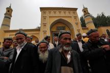 Muslim men of the Uighur ethnic group leave the Id Kah Mosque after Friday prayers in Kashgar, Xinjiang Uighur Autonomous Region, China. Photo: EPA
