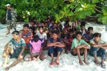 This handout picture taken on June 11, 2019 and released by Department of National Parks, Wildlife and Plant Conservation (DNP) on June 12 shows a group of Rohingya Muslims sitting on the sand at the Tarutao Marine National Park on Rawi island, southern Thailand. Photo: Department of National Parks, Wildlife and Plant Conservation (DNP)/AFP