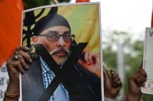 A member of United Hindu Front organisation, at a New Delhi rally, holds a banner depicting Gurpatwant Singh Pannun, a lawyer and US citizen reportedly targeted for assassination by an Indian official