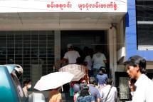 (File) People queue outside a bank in Yangon, Myanmar, 24 March 2020. Photo: EPA