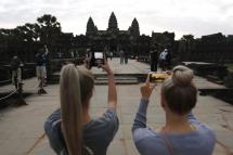 Tourists take pictures at the Angkor Wat temple in Siem Reap, Cambodia. Photo: EPA