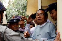 (File ) Dr Aye Maung (C), Ann Township MP and former Arakan National Party leader, speaks to the media while being escorted out of court by police officers after his hearing at Sittwe court in Sittwe, Myanmar, 06 March 2019. Photo: Nyunt Win/EPA