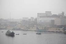 Passengers cross the Buriganga River in ferry boat during the winter on a foggy day in Dhaka, Bangladesh. Photo: EPA