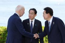 U.S. President Joe Biden, from left, Japanese Prime Minister Fumio Kishida and South Korean President Yoon Suk Yeol greet each other during a photo session during the G7 Hiroshima Summit in Hiroshima, Japan, 21 May 2023. Photo: EPA