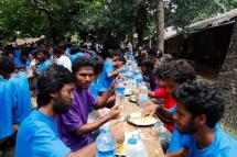 Rohingya Muslims from Bangladesh rescued by the Myanmar navy eat food together at a temporary refugee camp in the village of Aletankyaw in the Maungdaw township of northern Rakhine state, Myanmar, 23 May 2015. EPA/NYUNT WIN
