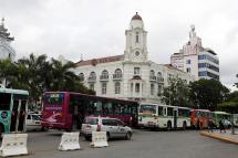 Buses stand in a traffic jam in front of the Ayeyarwady Bank (AYA Bank) in downtown Yangon. Photo: Nyein Chan Naing/EPA
