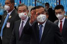 Cambodia’s Prime Minister Hun Sen (2nd R) gestures as Chinese Foreign Minister Wang Yi (centre L) looks on as they attend a handover ceremony of the Morodok Techo National Stadium, funded by China's grant aid under its Belt and Road Initiative, in Phnom Penh on September 12, 2021. TANG CHHIN Sothy / POOL / AFP